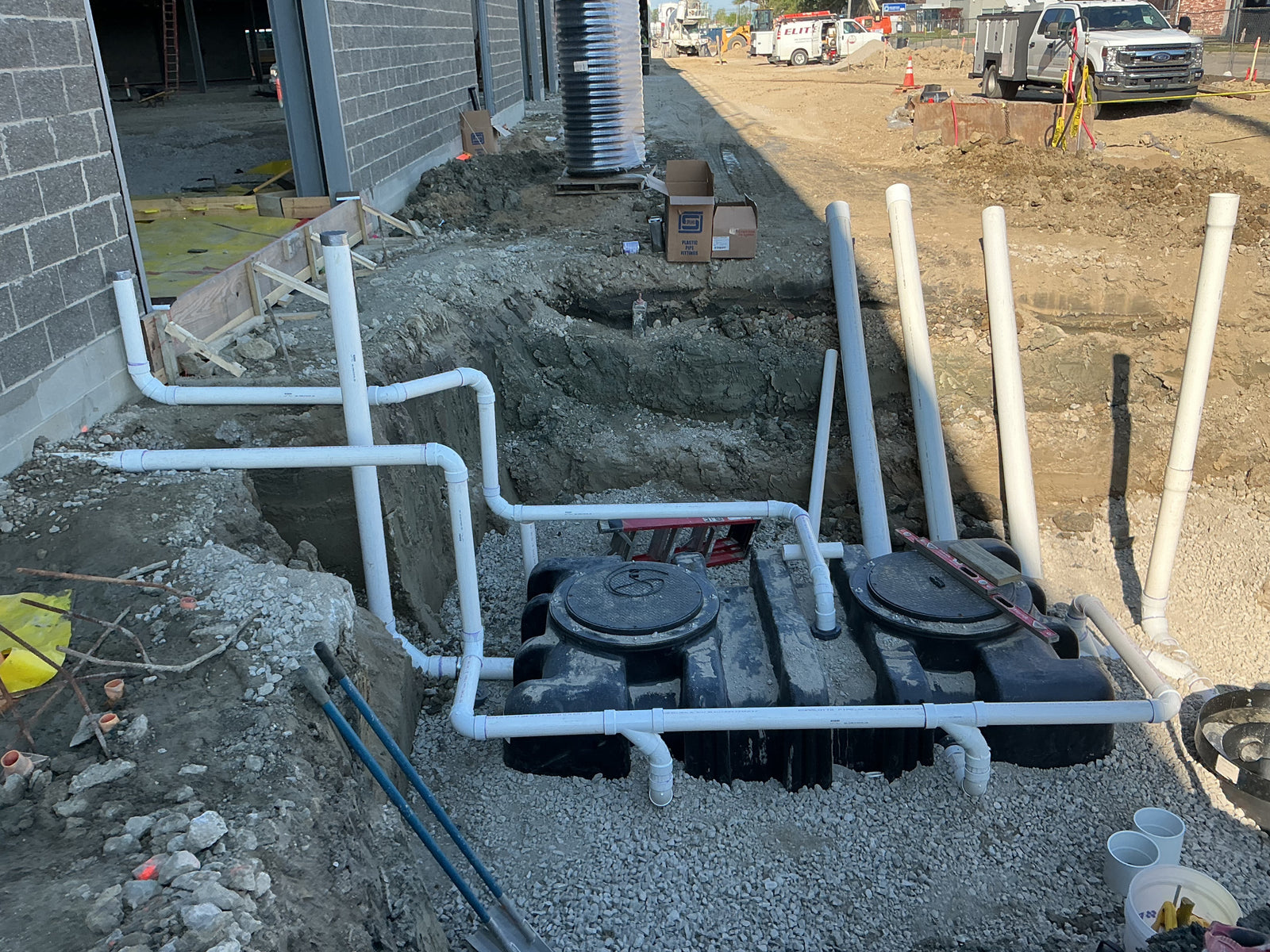 Interceptor tanks and PVC drainage piping installed on a commercial site by Hassig Companies, Macomb County MI