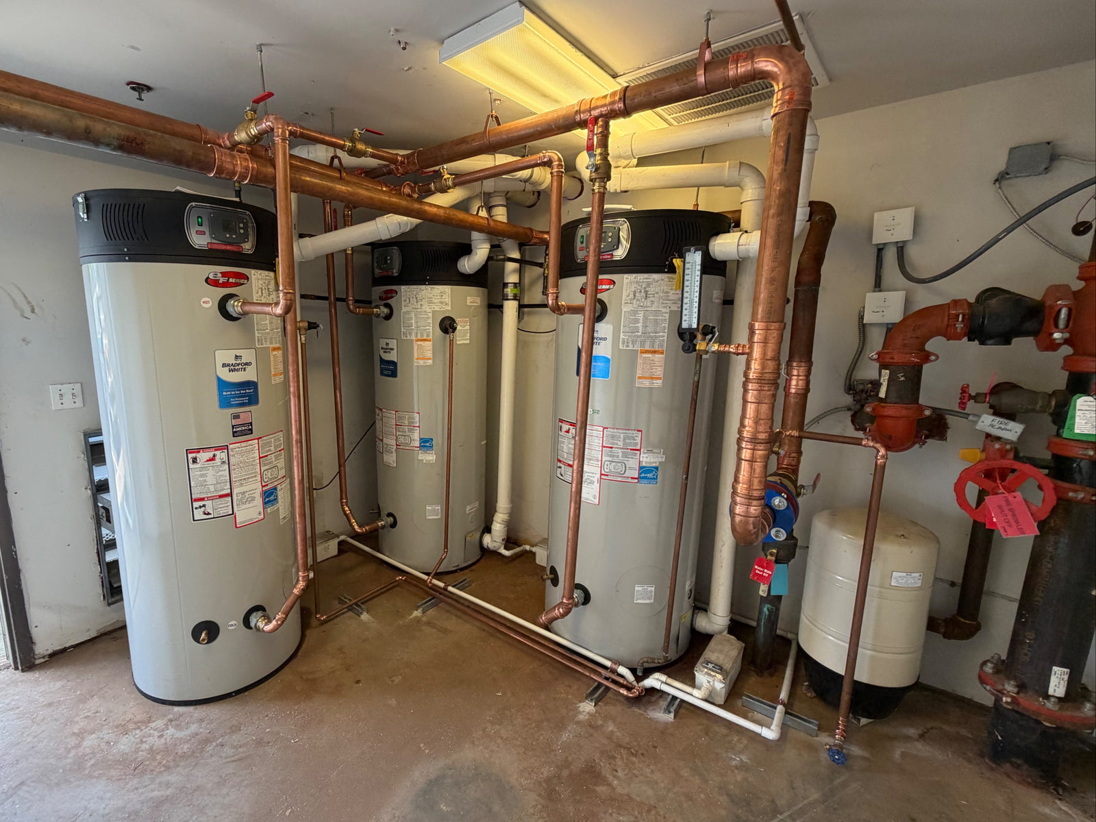 Commercial water heater room with copper piping manifold by Hassig Companies, Macomb County MI